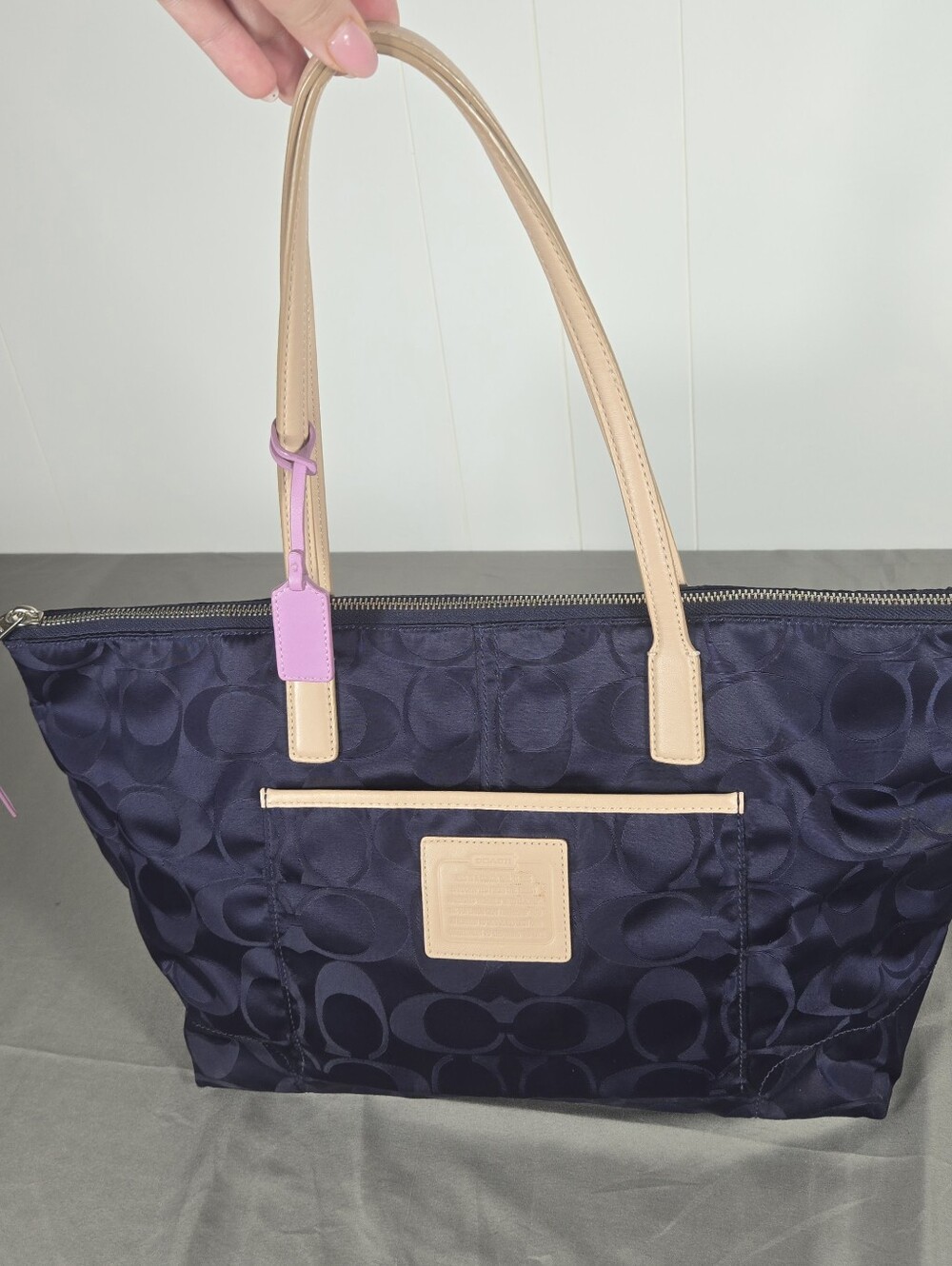 Coach Navy Tote with Beige Handles and Pink Tag Accent
